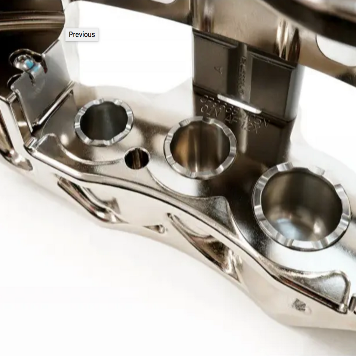 Close-up of a metallic engine component on a white background